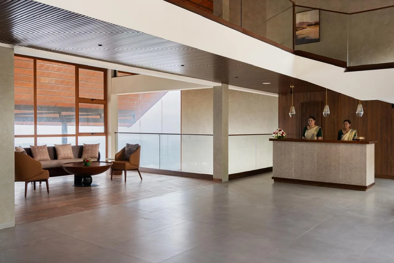 Olive Woods Munnar resort exterior with lush green hills