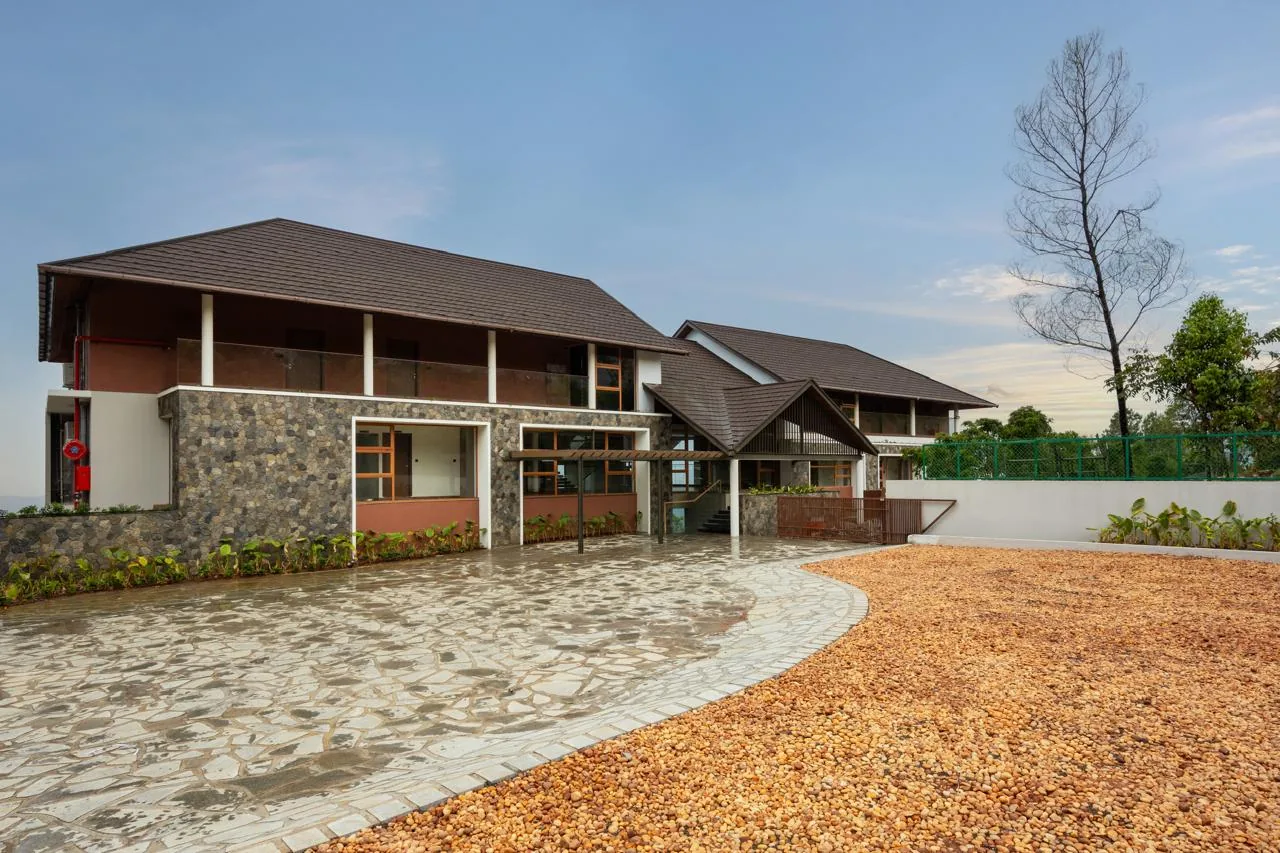 Olive Woods Munnar – premium resort entrance and hillside setting